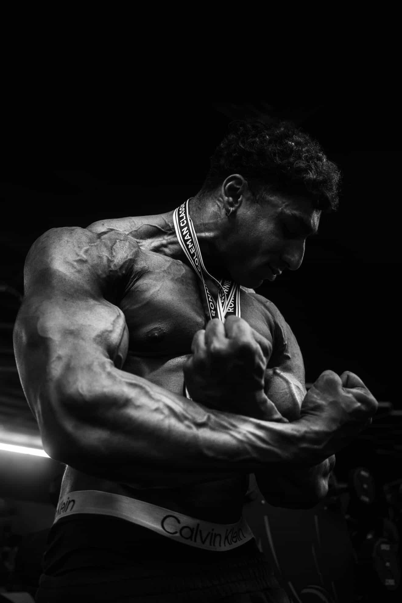 Manas Shashigari flexing in a black and white portrait
