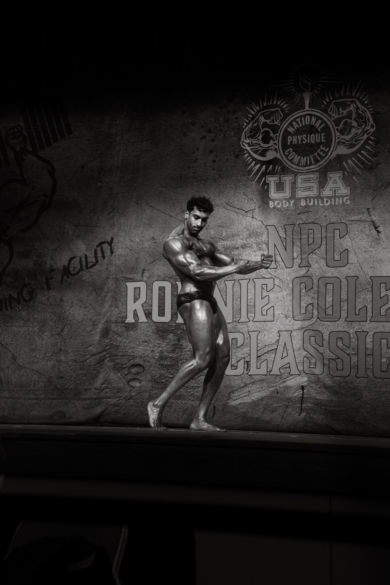Manas Shashigari posing on a bodybuilding stage